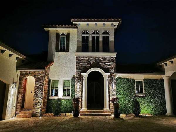 Home exterior at night with lights on